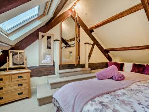 a bedroom with a bed and a tv and stairs at 2 Bed in Coleford 78181 in Symonds Yat