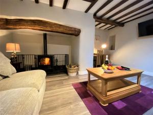 a living room with a table and a fireplace at 4 Bed in Conwy 66510 in Llanrwst