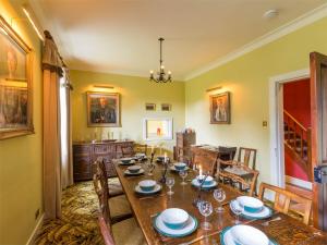 a dining room with a long table and chairs at 6 bed in Lairg CA301 in Lairg
