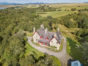 an aerial view of a large house in a field at 6 bed in Lairg CA301 in Lairg