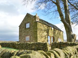 an old stone house behind a stone wall at 2 Bed in Tansley 78219 in Tansley