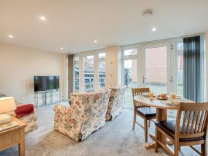 a living room with a table and chairs and a tv at 1 bed property in Godshill 77796 in Downton
