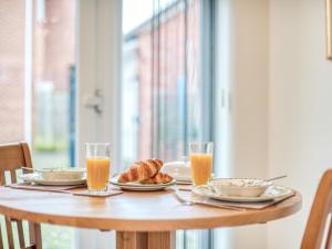 a table with food and glasses of orange juice at 1 bed property in Godshill 77796 in Downton