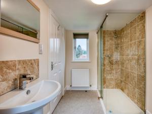 a bathroom with a tub and a shower at 1 bed property in Godshill 77796 in Downton