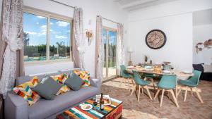 a living room with a couch and a table at PROFUMO DI ZAGARA 6&2 Emma Villas in Ispica