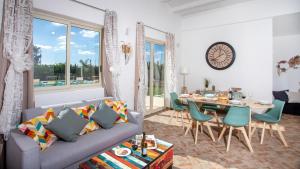 a living room with a couch and a table at PROFUMO DI ZAGARA 6&2 Emma Villas in Ispica