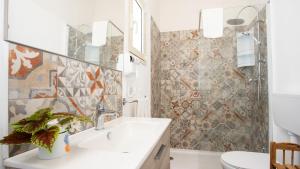 a bathroom with a sink and a shower at PROFUMO DI ZAGARA 6&2 Emma Villas in Ispica +25 photos