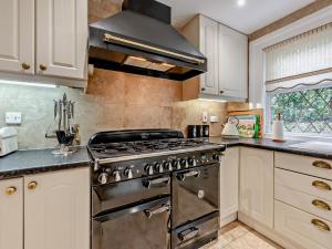 a kitchen with a stainless steel stove and a window at 4 Bed in Totland Bay IC032 in Totland