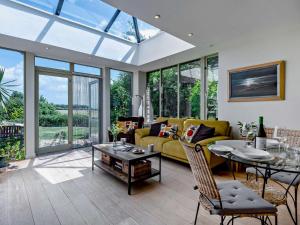 a living room with a yellow couch and a table at 1 Bed in Isle of Purbeck IC176 in Worth Matravers