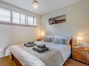 a bedroom with a bed with two pillows on it at 1 Bed in Isle of Purbeck IC176 in Worth Matravers