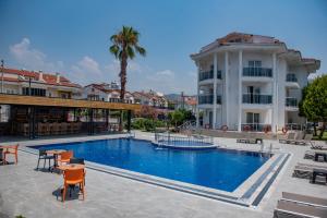 a large swimming pool in front of a building at Calis Beach Random Rooms by LookBookHoliday in Fethiye