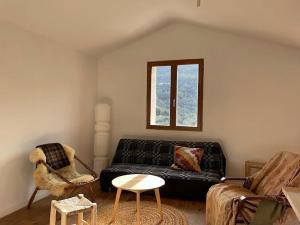 a living room with a couch and a chair at Cozy Catalan Cottage in Reynès