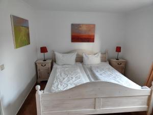 מיטה או מיטות בחדר ב-Ferienwohnung Winter