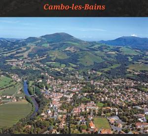 an aerial view of a town in the mountains at SUPERBE APPART AVEC JARDIN ET PISCINE in Cambo-les-Bains