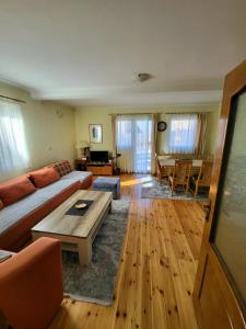 a living room with a couch and a table at Apartments center Zorić in Žabljak