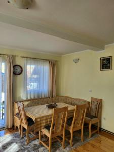 a dining room with a table and chairs and a couch at Apartments center Zorić in Žabljak