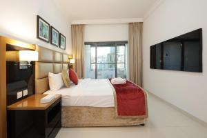 a hotel room with a bed and a television at SHH - Spacious 2 Bedroom Apartment in Capital Bay Tower B, Business Bay in Dubai