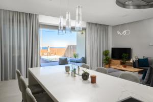 a living room with a large white table and chairs at Anasa Luxury Villas with Heatable Pool in Kokkini Khanion