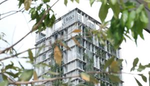 a tall building with plants on the side of it at Lloyd's Inn Kuala Lumpur in Kuala Lumpur
