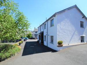 a white building on a street with trees at 1 Bed in Keswick 85419 in Keswick