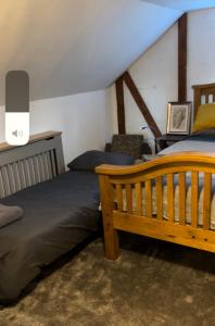 a bedroom with two beds and a chair at I bedroom flat on a gated farm in Tadworth in Purley