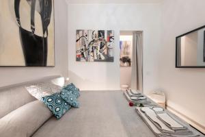 a living room with a couch and paintings on the wall at Falcone, 5 - Downtown apartment in Milan