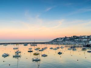 a group of boats in a harbor at sunset at 4 Bed in Brixham 82519 in Brixham