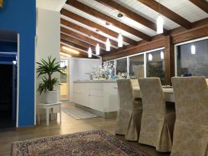 a kitchen with a dining table and chairs at Villa Alba Cefalù in Cefalù +27 photos