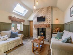 a living room with two couches and a fireplace at 3 Bed in Belper 83037 in Hazelwood