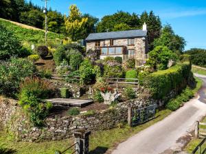 a stone house on a hill with a garden at 2 Bed in Abergavenny 83894 in Llanover