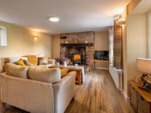 a living room with a couch and a fireplace at 2 Bed in Abergavenny 83894 in Llanover