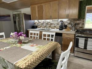 a kitchen with a table and a counter top at Secluded house, Opening special in Pahoa