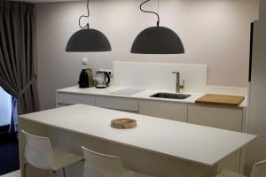 a kitchen with two pendant lights and a sink at Strasbourg Entzheim in Entzheim