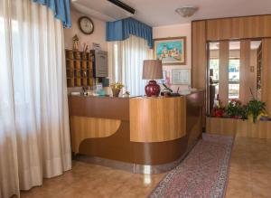 a lobby with a reception desk in a building at Hotel Santa Maria in Assisi