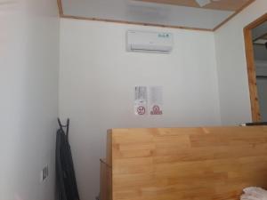a room with a wooden door and a wall at Fulidhoo Hathaa Retreat in Fulidhoo