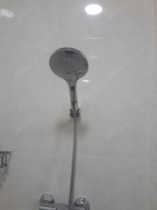 a shower head hanging on a white wall at Fulidhoo Hathaa Retreat in Fulidhoo