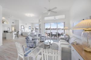 a living room with a couch and a table at Waterfront home with views, pool and walk to beach in Marco Island