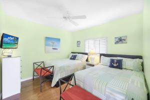 a bedroom with two beds and a chair in it at Waterfront home with views, pool and walk to beach in Marco Island +53 photos