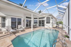 a swimming pool in a house with a glass ceiling at Waterfront home with views, pool and walk to beach in Marco Island