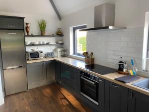 a kitchen with stainless steel appliances and a window at mary-tim's Cromane Cross near Killorglin in Killorglin