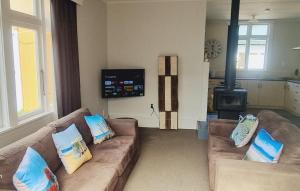 a living room with two couches and a stove at Middle of Everywhere in Motueka