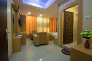 a hotel room with a bed and a living room at CITY VIEW, Port Blair in Port Blair