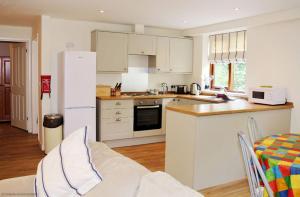 a kitchen with white cabinets and a white refrigerator at Pleasure Row in Alton