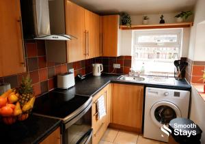 a kitchen with a sink and a washing machine at Stylish 2 Bed House In The Heart Of Clitheroe By Smooth Stays Short Lets & Serviced Accommodation With Parking in Clitheroe