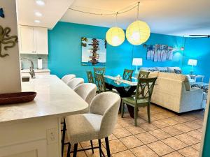 a kitchen and living room with a table and chairs at Leaward Isle Island Retreat in Key West