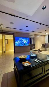 a living room with a fish tank on the wall at Damac Jeddah 1408 in Jeddah