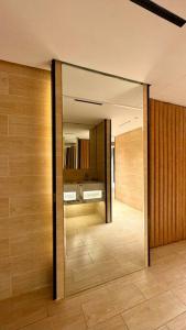 a hallway with a large mirror in a room at Damac Jeddah 1408 in Jeddah