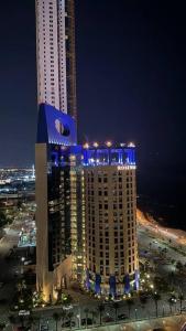a large building with blue lights on top of it at Damac Jeddah 1408 in Jeddah