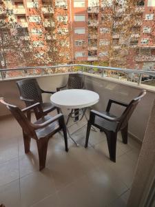 a white table and chairs on a balcony at Downtown Great Apartment in Strumica