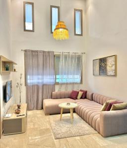 - un salon avec un canapé et une table dans l'établissement Take a cosy rest Near the airport, à Nouaceur
